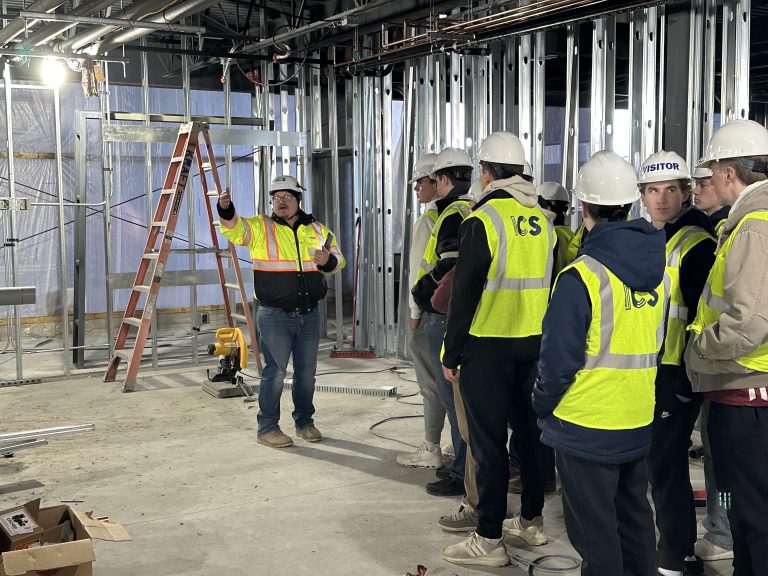 LARC construction site supervisor Brad Lund points out work being done on the second floor of the facility while leading a tour for students from Litchfield High School.